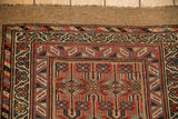 Antique Serab runner corner displaying geometric main border, brick red, dusty sapphire, and camel hair.