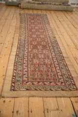 Antique Serab runner geometric field and main border in brick red, blue, and sandy tones.