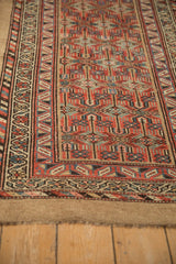 Intricate geometric patterns and pile texture of antique Serab runner in brick red, dusty blue, camel.