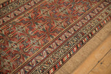 Antique Serab runner's natural camel hair outer edge and brick red geometric main border.