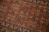 Antique Serab rug detail, geometric blossoms and serrated border, with natural camel hair pile.