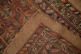 Antique Serab runner's hand-knotted camel-toned back, original side selvage, and geometric pattern.