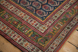 Antique Northwest Persian rug corner, showcasing deep green main border and intricate geometric patterns.