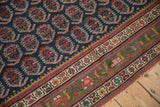 Antique Northwest Persian rug: navy field of red boteh motifs, and unusual deep green main border.