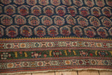 Antique Northwest Persian carpet's deep green main border with geometric motifs and light fringe.