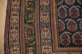Intricate borders of an antique Northwest Persian rug, featuring a deep green stylized bird band.