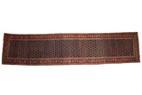 Antique Bijar runner featuring a navy blue lattice field and a madder red meandering vine border.