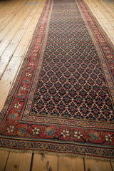 Antique Bijar runner shown at full length, highlighting the repeating navy lattice and red floral border.