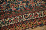 Intricate floral and geometric borders of an antique Persian Mahal showing its even, low pile.