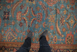 Antique Mahal rug's abrashed blue field and Herati pattern underfoot.
