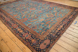Antique Mahal carpet corner showing multi-tiered floral border and abrashed sky blue field.