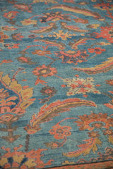 Abrashed sky blue ground of an antique Mahal carpet with vivid Herati floral motifs.