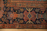 Antique Mahal carpet's brick red, multi-tiered rainbow floral main border with indigo field.
