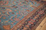 Multi-tiered rainbow floral border in navy, blush, and gold on antique Mahal rug's sky blue Herati field.