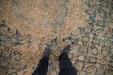 Hand-knotted antique Hamadan carpet showcasing distressed indigo and sand geometric patterns.