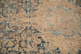 Distressed antique Persian Hamadan rug displaying indigo blue and sand motifs with worn pile and foundation.