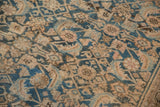 Worn indigo blue and sand motifs on a distressed antique Hamadan carpet.