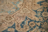 Distressed Hamadan carpet detail, showing worn pile, knot heads, and geometric blue motifs.