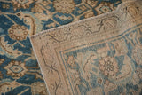 Worn pile texture of antique Hamadan rug, showing indigo, sand motifs and visible foundation.