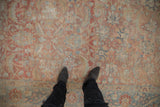 Distressed vintage Tabriz carpet's abrashed field with faded ruby red and blue Herati design.