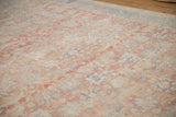 Distressed vintage Tabriz carpet's surface, showing faded Herati vinery and abrashed blush tones.