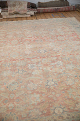 Distressed vintage Tabriz carpet showcasing faded Herati design, visible knot heads, and blush tones.