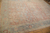 Distressed Herati motif with scrolling palmettes and vinery on the abrashed ruby red field.