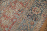Distressed vintage Tabriz carpet showing storied texture of ruby red and dusty blue Herati.