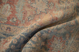 Distressed vintage Tabriz carpet's textural surface with muted Herati pattern in rose, blue, sand.