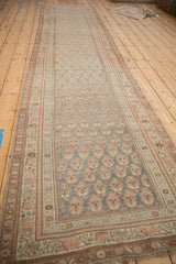 Distressed antique Bijar rug runner showing meandering vine triple borders and muted boteh field.