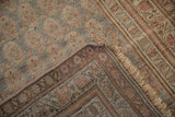 Antique distressed Bijar rug with muted boteh field, patterned border, selvage, and reverse weave.