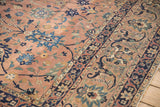 Antique Kerman carpet: detailed navy and dusty coral arabesques with scrolling vinery.
