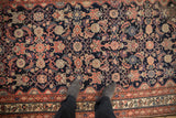 Antique Malayer rug displaying Herati design with navy, blush, beige, and faded orange tones.