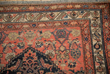 Antique Malayer rug corner, featuring multi-layered borders in dusty blush, navy, and beige tones.