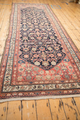 Cream fringe and patterned coral, beige, navy end border on the antique Malayer runner.