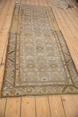 Angled view of distressed vintage Kurdish Hamadan runner with abrashes and subtle Herati motif.