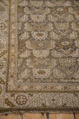 Distressed Kurdish Hamadan rug detail with worn olive gold, silver, and ivory field motifs.