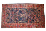 Vintage Mohajeran Sarouk carpet: deep navy field, brick red border with palmettes, floral vinery.