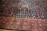 Vintage Mohajeran Sarouk carpet: navy floral field meets brick red palmette border.