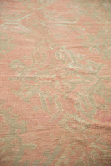 Distressed pile revealing floral patterns and knot heads in dusty blush and silver tones.
