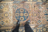 Distressed vintage Khotan rug: visible foundation wear with mauve, cobalt, saffron colors.