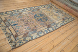 Distressed Khotan runner corner: geometric cobalt blue border, mauve field, trefoil buds, visible wear.