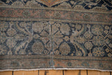 Storied seam repair and worn pile on an antique Mohtashem Kashan's floral border.