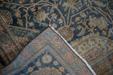 Antique Persian carpet corner folded to show the dense hand-knotted weave and secured selvage edge.