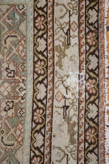 Antique distressed Malayer runner with geometric border patterns, worn pile, and fringed edge.