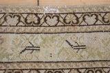 Distressed antique Malayer rug with geometric border and dusty olive green Herati field.
