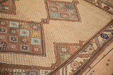 Diamond medallion with floral guls on the geometric beige lattice field of an antique Persian rug.