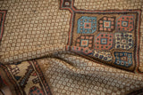 A draped view showing the even wear of the ivory lattice field and colorful gul motifs.