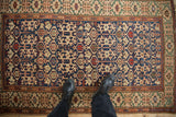 Antique Caucasian rug's colorful Koneghand field with scattered snakes and geometric Kufic borders.