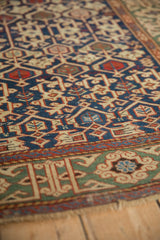 Geometric Koneghand field and Kufic border detail in navy, madder red, and sand tones.